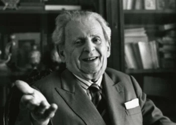 Photo of Emmanuel Levinas with his hand outstretched to the viewer