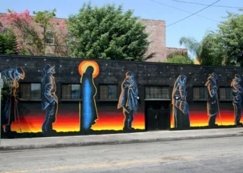 Mural with silhouettes of 7 figures in a line, one of whom seems to be Jesus